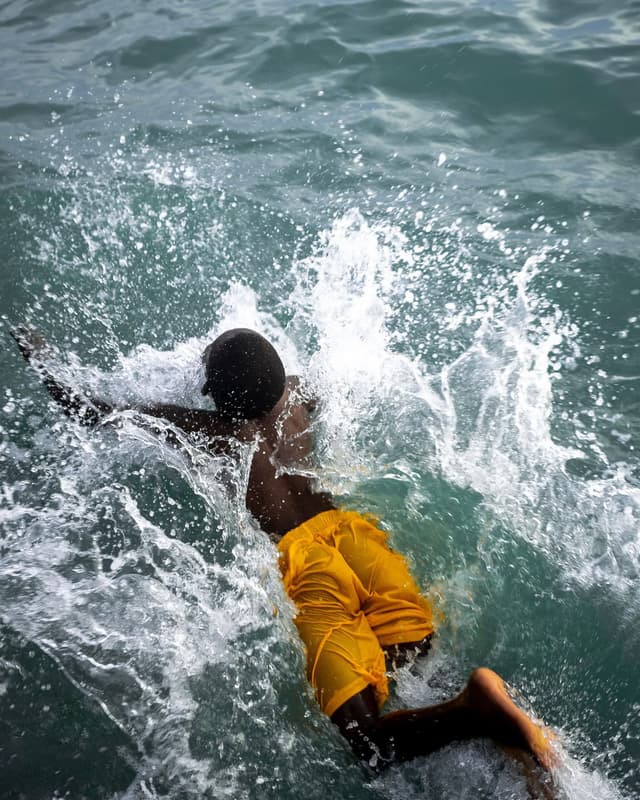 Swimmer splashing into the water