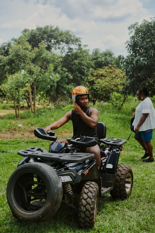 Helmeted rider seated on a quad bike outdoors