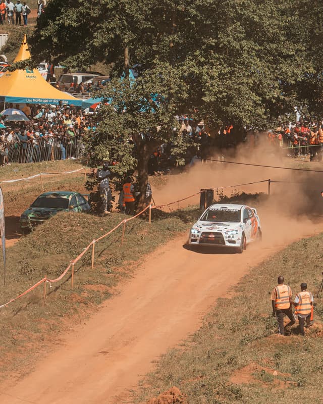 Rally car racing past spectators at Garuga
